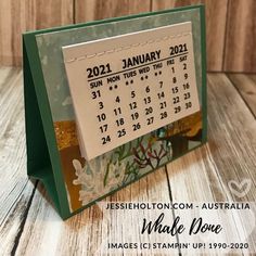 a desk calendar is displayed on a wooden table