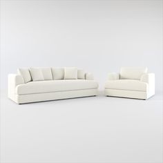 two white couches sitting next to each other on top of a white flooring