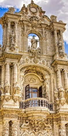 an ornate building with statues on the outside