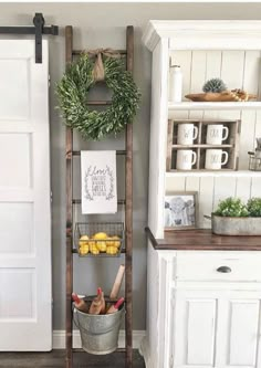 an old wooden ladder is used as a shelf for fruit and vegetables in this kitchen