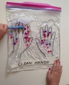 two hands are shown on a plastic bag with the words clean hands written on it