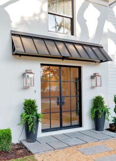 an image of a white house with black doors