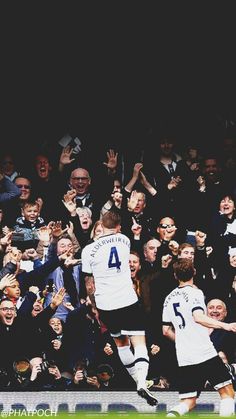 two soccer players are in the middle of a crowd