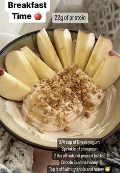 a bowl filled with yogurt, apples and granola on top of it