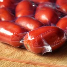 a bunch of red tomatoes wrapped in plastic