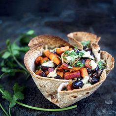 a pita filled with black beans, carrots and cilantro