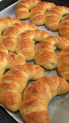 freshly baked croissants sitting on a baking sheet