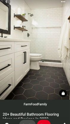 a bathroom with black and white flooring and hexagonal tiles on the walls