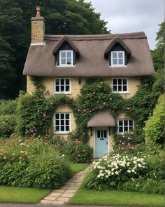 a house with flowers growing all around it