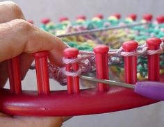 a person is knitting on an object with yarn and crochet needles in their hands