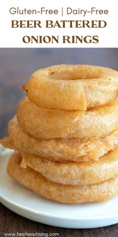 gluten - free, dairy - free beer battered onion rings on a white plate