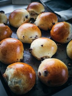 freshly baked rolls sitting on top of a baking sheet