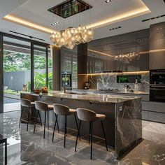 a modern kitchen with marble counter tops and bar stools