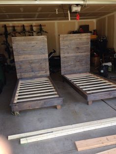 two beds made out of wood in a garage