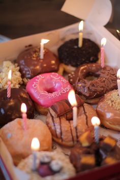 a box filled with lots of different types of donuts