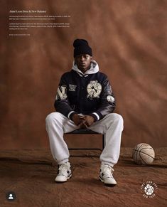 a man sitting on top of a chair next to a basketball and wearing a hat