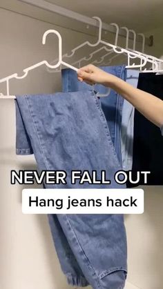 a person hanging jeans on a rack with the caption never fall out hang jeans hack