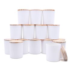 a stack of white cups with wooden lids