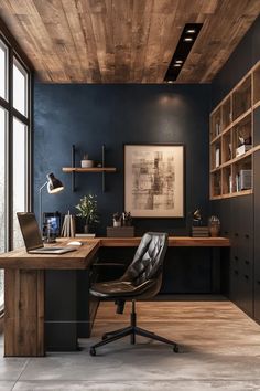 a home office with dark blue walls and wooden ceilinging, black leather chair and desk