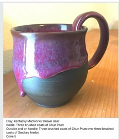 a purple cup sitting on top of a wooden table