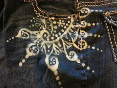 a pair of jeans with an embroidered design on them