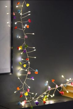 a christmas tree with multicolored lights on it