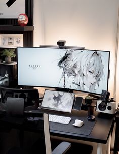 a computer monitor sitting on top of a desk next to a keyboard and mouse pad