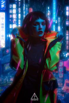 a woman standing in the rain wearing a neon coat