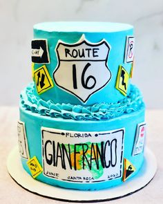 a three tiered cake decorated with blue icing and street signs