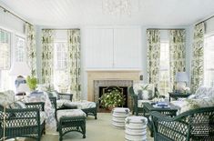 a living room filled with furniture and a fire place in the middle of a room