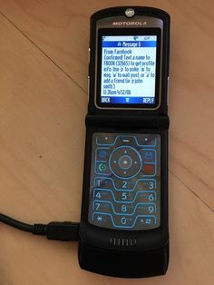 a cell phone sitting on top of a wooden table