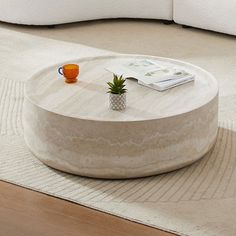 a coffee table sitting on top of a white rug