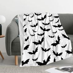 a black and white bat pattern blanket on a couch