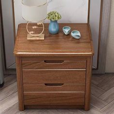 a wooden table with two drawers and a lamp on top