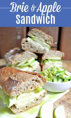 a sandwich cut in half sitting on top of a table next to some sliced apples