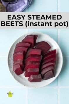 sliced beets in a white bowl on a blue tile counter top with text overlay that reads easy steamed beets instant pot