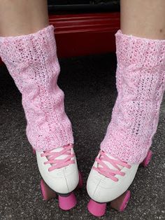 a close up of a person wearing pink roller skates and socks with laces on them