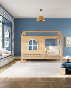 a child's bedroom with blue walls and wooden furniture, including a bed frame