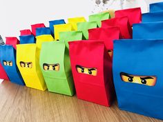 colorful bags with eyes are lined up on the floor