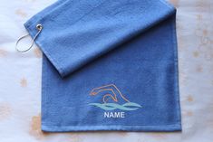 a blue towel with an image of a house on it and the name namme