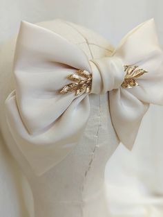 A beautiful cream hair bow with gold tone etched leaves.  This hair bow is the perfect shade of cream and gold for the festive season and would compliment your festive outfit wonderfully, wether it be a cosy Christmas jumper or your favourite party dress! *DETAILS*  * The bow is attached to a silver french Barrett hair clip * measurements - 14cm across * your bow will arrive in a gift box with luxury ribbon.  *DELIVERY DEATAILS* All UK orders are sent via the Royal Mail 1st Class Signed for serv Leaves Hair Accessories, Luxury Elegant Bow For Business, Diy Satin Bow, Hair Bow Design, Bridal Hair Bow, Wedding Hair Bow, Bridal Bow, Satin Hair Bow, Gold Hair Bow