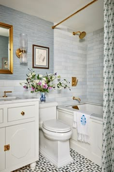 a white toilet sitting next to a bath tub