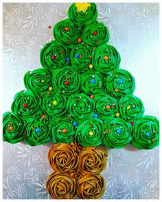 a green christmas tree made out of rolled up paper and some gold colored spirals