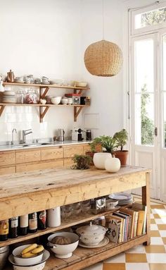 a kitchen with wooden shelves and white walls