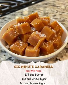 a bowl full of caramels sitting on top of a counter next to a piece of paper