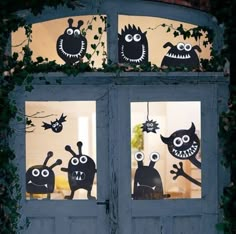 an open door decorated with fake monsters and bats