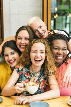 a group of people sitting at a table with coffee