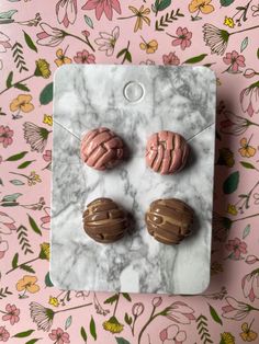 three different colored buttons sitting on top of a marble surface