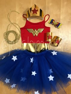 a red shirt and blue tutu skirt with gold stars on the bottom is next to an american flag pinata