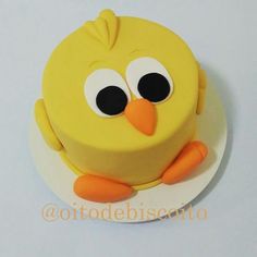 a yellow cake with an owl face on it